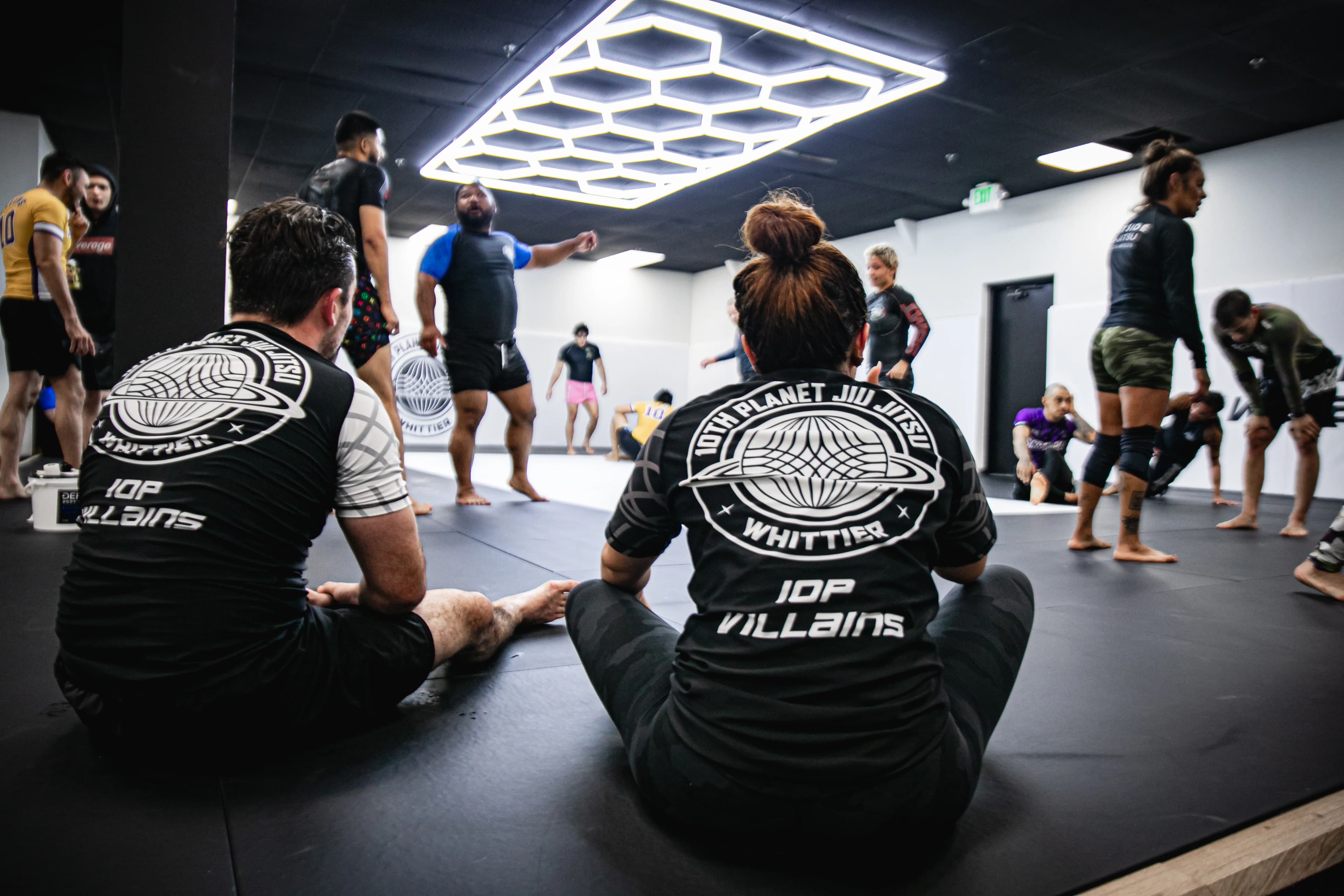 10P Whittier athletes drilling no-gi positions on the mats.